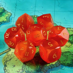Puede incluir: Conjunto de siete dados poliédricos naranja translúcidos con numeración dorada. Los dados están dispuestos sobre un mapa, mostrando sus diferentes caras y números, perfectos para juegos de mesa.