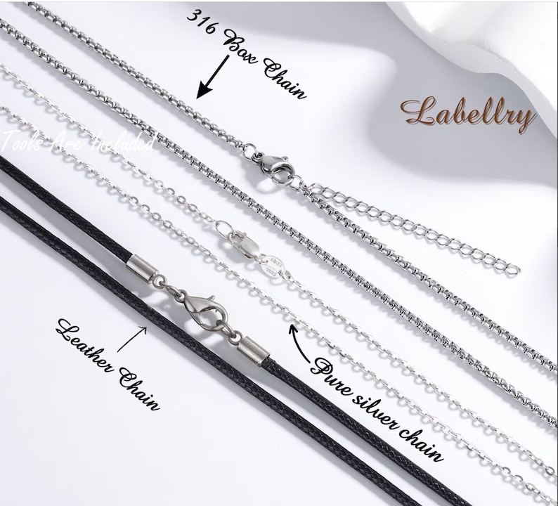 May include: An assortment of necklaces, including a 316 box chain, a leather chain, and a pure silver chain. The chains are silver and black, with clasps and extension chains. The word "Labellry" is in the upper right corner.