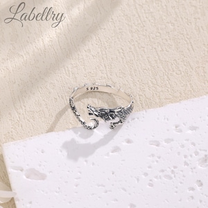 May include: Silver dragon ring with a detailed design. The ring is marked with "S 925" on the inside.