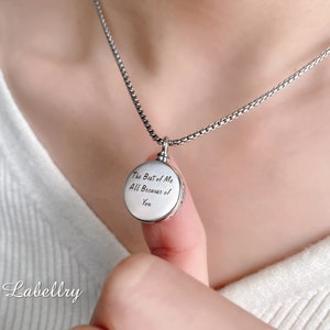 May include: A silver-colored round pendant necklace with the inscription "The Best of Me All Because of You." The pendant hangs from a delicate chain. The necklace is a memorial or keepsake item.