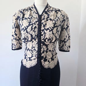 Vintage 1940s white floral lace print over navy blue crepe dress.