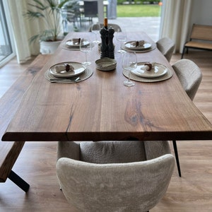 Solid walnut dining table with natural tree edge