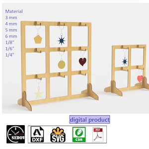 May include: A digital download of a wooden keychain display stand with nine slots. The stand is made of 3 mm, 4 mm, 5 mm, 6 mm, 1/8 inch, 1/6 inch, and 1/4 inch thick wood. The stand is shown with a variety of keychains, including a star, a heart, and a circle.