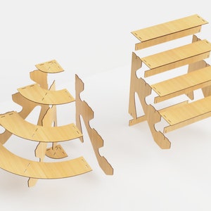 May include: Two unfinished wooden display stands. One is a tiered, curved design, and the other is a stepped, rectangular design. Both are made of light-colored wood and are unassembled, with slots for easy construction. Ideal for showcasing small items.