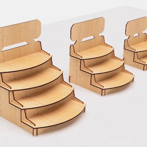 May include: Three wooden display stands with four shelves each. The stands are made of light brown wood and have a simple, modern design. The shelves are curved and have a slight lip to prevent items from falling off.