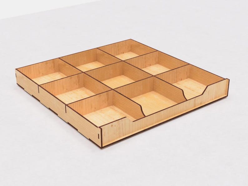 May include: A wooden organizer with nine compartments, perfect for storing small items. The organizer is made of light wood with a natural finish.