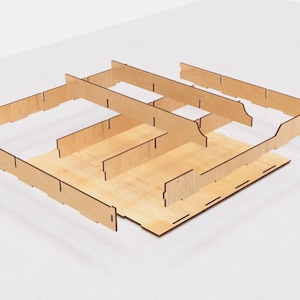 May include: A set of wooden dividers for organizing a board game. The dividers are made of light brown wood and are arranged in a grid pattern. The dividers are designed to fit together to create a custom storage solution for board games.