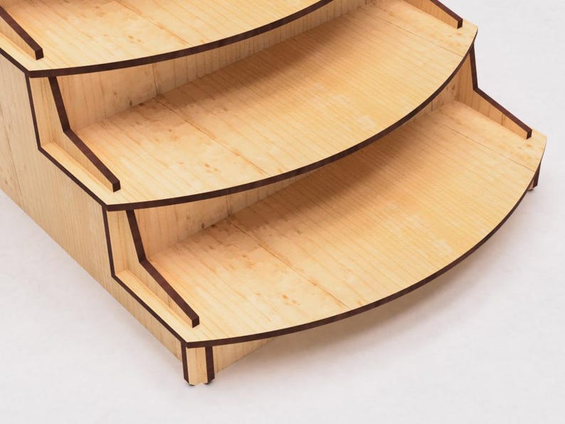 May include: A wooden tiered stand with four shelves. The shelves are curved and have a dark brown trim. The stand is made of light wood with a natural finish.