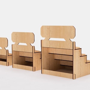 May include: Three wooden display stands with tiered shelves. The stands are made of natural wood and have a simple, rustic design. The largest stand has five shelves, the middle stand has three shelves, and the smallest stand has two shelves.