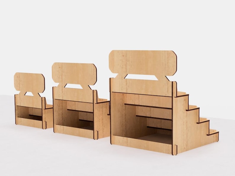 May include: Three wooden display stands with tiered shelves. The stands are made of natural wood and have a simple, rustic design. The largest stand has five shelves, the middle stand has three shelves, and the smallest stand has two shelves.