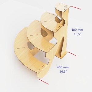 May include: A wooden, three-tiered, curved step stool. The stool is made of light-colored wood and has a unique, open design. Each step is a semi-circle. The height is 16.5 inches (400 mm).
