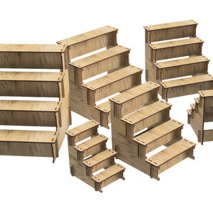 May include: Set of six wooden tiered display stands in various sizes. The stands are made of natural wood and have a rustic look. They are perfect for displaying small items, such as jewelry, candles, or other crafts.