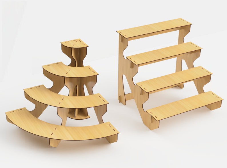 May include: Two wooden display stands. One is a curved, three-tiered stand with a triangular top. The other is a four-tiered, stepped stand. Both are made of light-colored wood and are designed for product display.