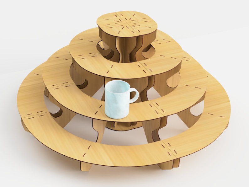 May include: A light wood-colored, tiered display stand with a circular design. The stand has three levels, each with a curved shape, and a small, light blue mug is placed on the middle tier. The stand is made of wood and has a modern design.