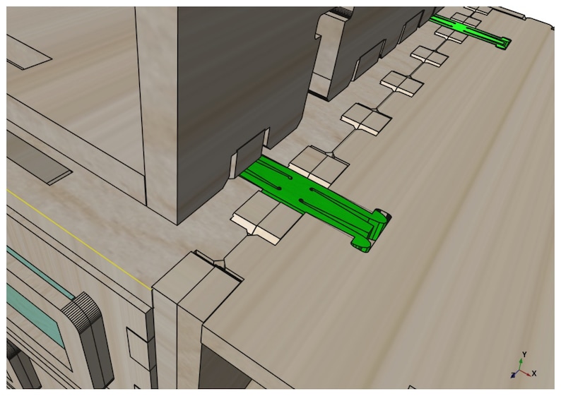 May include: A close-up of a green plastic connector piece, with a series of square cutouts, fitting into a wooden frame.