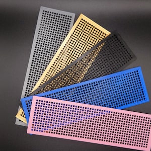 May include: Five plastic mesh sheets in different colours: grey, gold, black, blue, and pink. The sheets are arranged in a fan shape, with the grey sheet at the top and the pink sheet at the bottom.