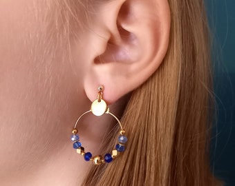 May include: Gold hoop earrings with blue and light blue crystal beads.