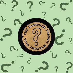 May include: A black and brown round sticker with the text "The Panicked Possum Mystery Pack" and a question mark in the center. The sticker is surrounded by green question marks on a light green background.