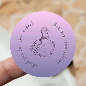 Peut inclure: Un autocollant rond avec un dégradé de couleur violet à rose. L'autocollant présente une illustration dessinée à la main d'une fiole de potion avec une étiquette qui indique "Love Potion". Le texte autour de la fiole indique "Merci pour votre commande ! Mahaksper fume potions".