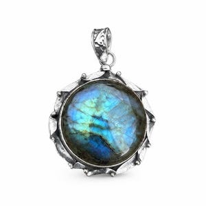 May include: A round pendant featuring a polished labradorite gemstone with iridescent blue and green flashes. The stone is set in a textured, oxidized silver frame with a scalloped edge and a decorative bail at the top for attachment to a chain.