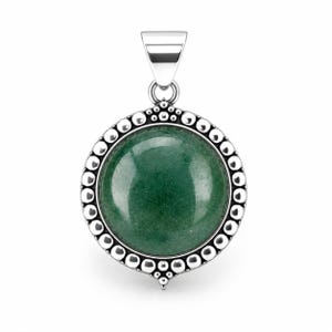 May include: A round pendant featuring a smooth, dark green circular stone set in a polished silver frame. The silver border is decorated with a series of small, raised metallic spheres, and the piece includes a tapered silver bail at the top.