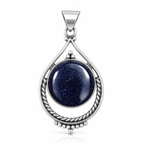 May include: A silver pendant featuring a round, dark blue goldstone cabochon with sparkling inclusions. The stone is set within a teardrop-shaped frame that includes twisted rope detailing, small silver beads at the base, and a triangular bail.