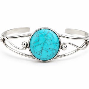 May include: A silver-toned cuff bracelet featuring a large, circular, bright turquoise stone with dark veining at the centre. The band is constructed from thin, polished metal wires that curve into wave-like patterns with small spherical accents.