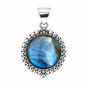 May include: A round pendant featuring a polished, iridescent blue labradorite gemstone set in a silver frame. The metal border is decorated with a series of small, raised silver spheres, and the piece includes a triangular silver bail at the top.