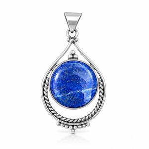May include: A silver pendant featuring a round, deep blue lapis lazuli stone with natural white and gold fleck inclusions. The stone is set within a circular frame of twisted silver rope detailing, accented by small silver beads at the top and bottom.
