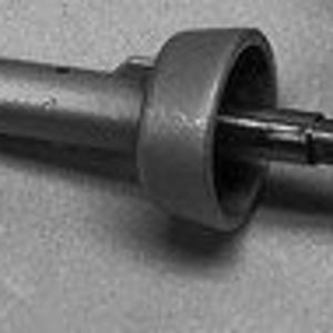 May include: A gray plastic bottle stopper with a metal pin and a round, flat top.
