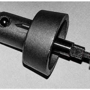 May include: Black plastic nozzle with a metal rod and a small black washer. The nozzle has a round opening and a small black ball in the center.