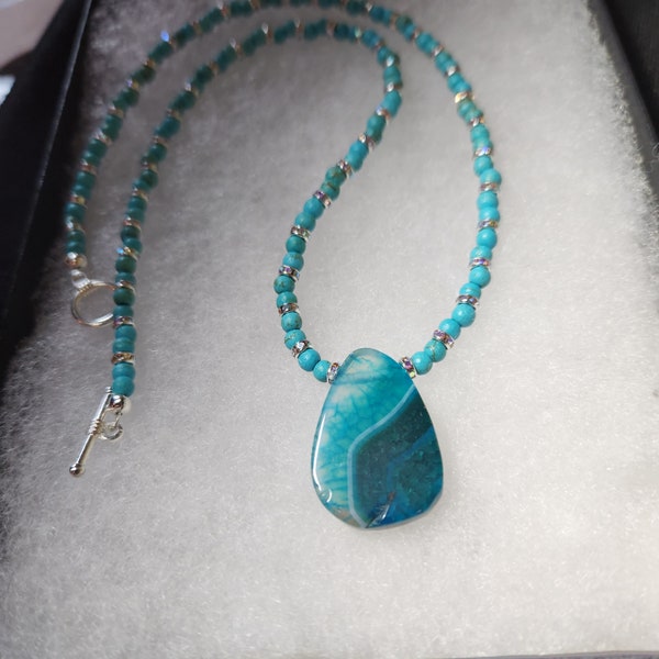 Teal agate and resin necklace sprinkled with rhinestones.