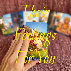 May include: A tarot card reading with the Empress card showing. The card is blue with a woman sitting on a throne in a green field. The text on the card reads "III The Empress".