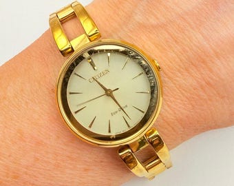 Citizen Eco-Drive Axiom Women's Gold Champagne Dial Watch 28mm EM0638-50P Works