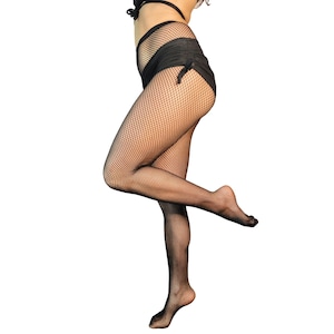 May include: Black fishnet stockings with a diamond pattern. The stockings are worn on a person's legs and feet.