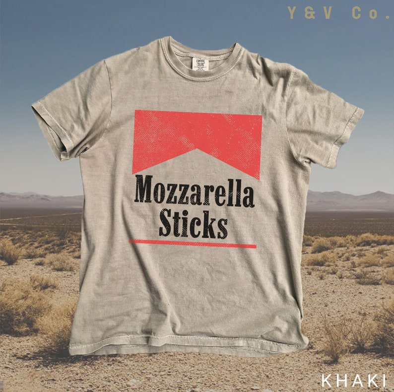 May include: A light grey t-shirt featuring a red and black graphic of a cigarette pack that reads "Mozzarella Sticks". The shirt is made from a soft, comfortable fabric and has a relaxed fit.