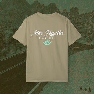May include: A tan t-shirt with a white graphic on the back that says "Mas Tequila Y&V Co." with a teal agave plant graphic.