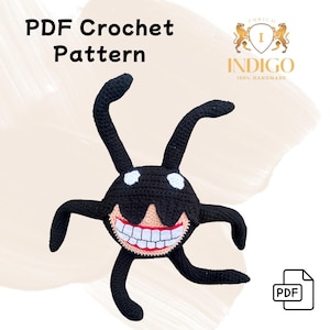 Può includere: Uno schema all'uncinetto per un mostro amigurumi nero e bianco con un grande sorriso e sei gambe. Lo schema è disponibile per il download in PDF. Lo schema è intitolato "PDF Crochet Pattern" e il nome del designer è "Indigo 100% Handmade".