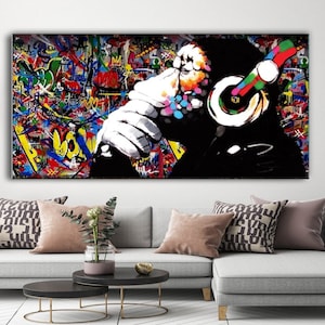 May include: A colorful abstract painting of a monkey wearing headphones. The background is a vibrant mix of graffiti-style lettering and shapes.