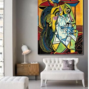 May include: A colorful painting of a woman with a red hat and a blue and green dress. She is crying and holding a white handkerchief to her face. The painting is done in a cubist style.