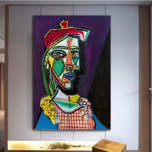 May include: A colorful abstract painting of a woman wearing a red beret. The woman's face is painted in a cubist style with geometric shapes and bright colors. The background is a dark purple.