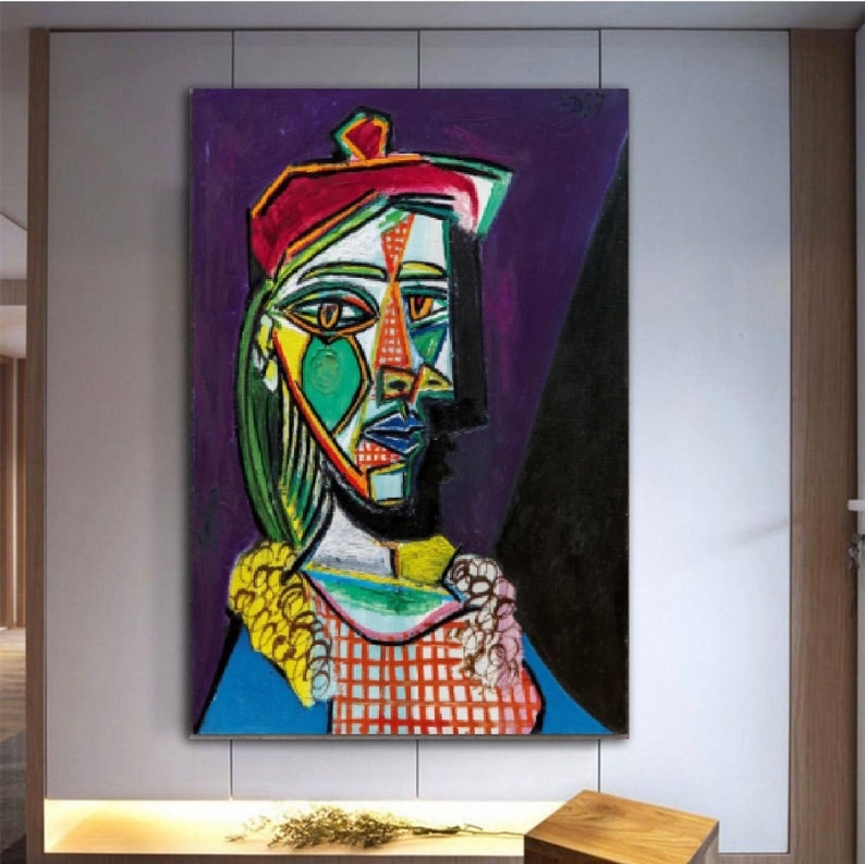 May include: A colorful abstract painting of a woman wearing a red beret. The woman's face is painted in a cubist style with geometric shapes and bright colors. The background is a dark purple.
