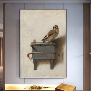 May include: A painting of a small bird perched on a wooden box with a curved metal handle. The bird is brown and yellow with a red spot on its head. The painting is signed "C. Fabritius 1654".