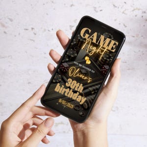May include: A smartphone displaying a digital invitation for a game night party. The invitation features a black background with gold text and graphics of dice and poker chips. The text reads "Game Night" and "You're invited to Oliver's 30th birthday 01/03/2023".