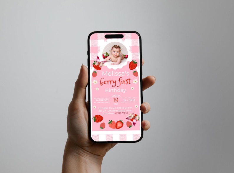 May include: A smartphone displays a pink invitation for "Melissa's berry first Birthday." The design features a baby's photo, strawberries, and a checkered pattern. The invitation includes the date, time, and location details.