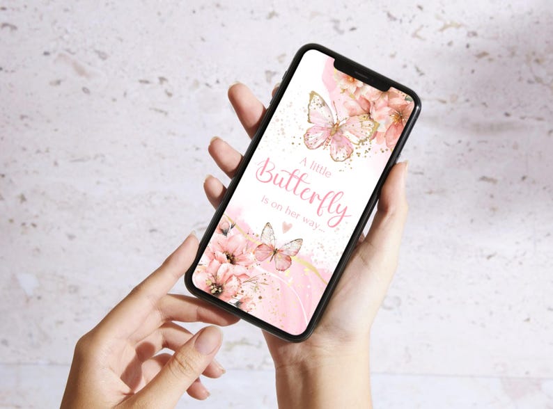 May include: A pink and gold smartphone wallpaper featuring a butterfly and flowers. The text on the wallpaper reads "A little Butterfly is on her way."