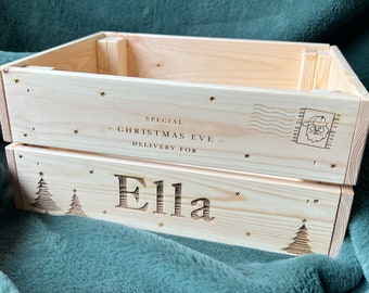 May include: A wooden crate with the text "SPECIAL CHRISTMAS EVE DELIVERY FOR Ella" and a Santa Claus post office stamp. The crate is decorated with small stars and Christmas trees.