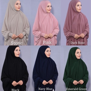 May include: Six different colours of a jersey knit hijab with long sleeves. The colours are stone, pink, dark rose, black, navy blue, and emerald green.