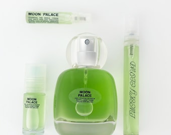 May include: A collection of Moon Palace fragrance products including a large glass perfume bottle, a small travel-sized spray vial, a rollerball bottle, and a thin sample spray, all containing a light green liquid with clear labelling.