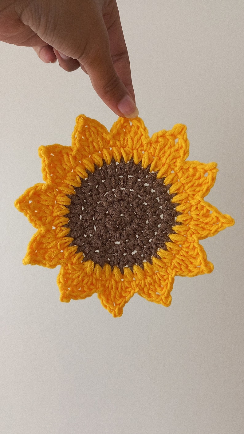 Holding up the sunflower drink coaster